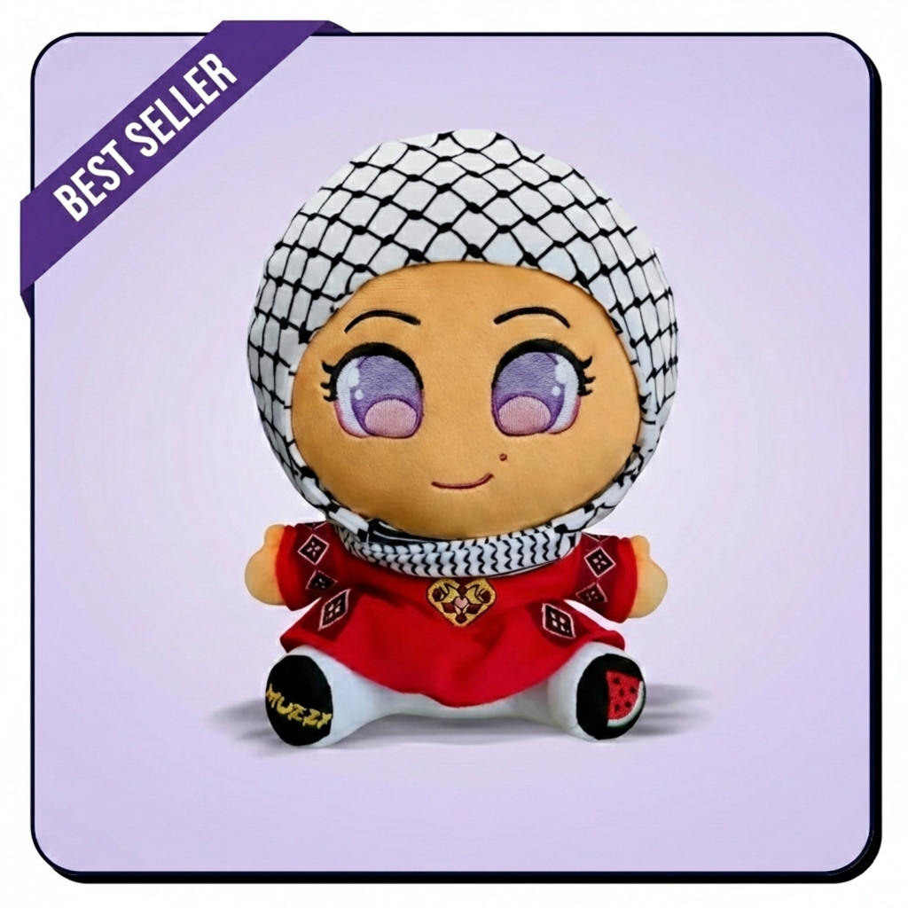 A plush doll with large purple eyes wearing a red dress and a black and white keffiyeh.