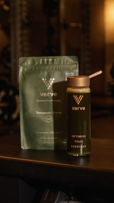 Green supplement packet and bottle labeled 'verve' on a dark surface.