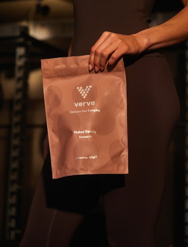 Person holding a brown package labeled 'verve' in a dimly lit setting.