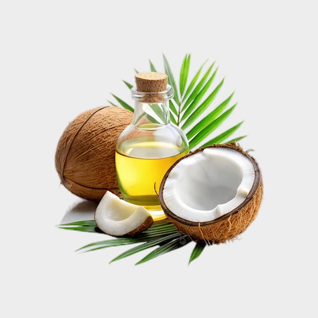 Coconut oil bottle with whole and halved coconuts on palm leaves.