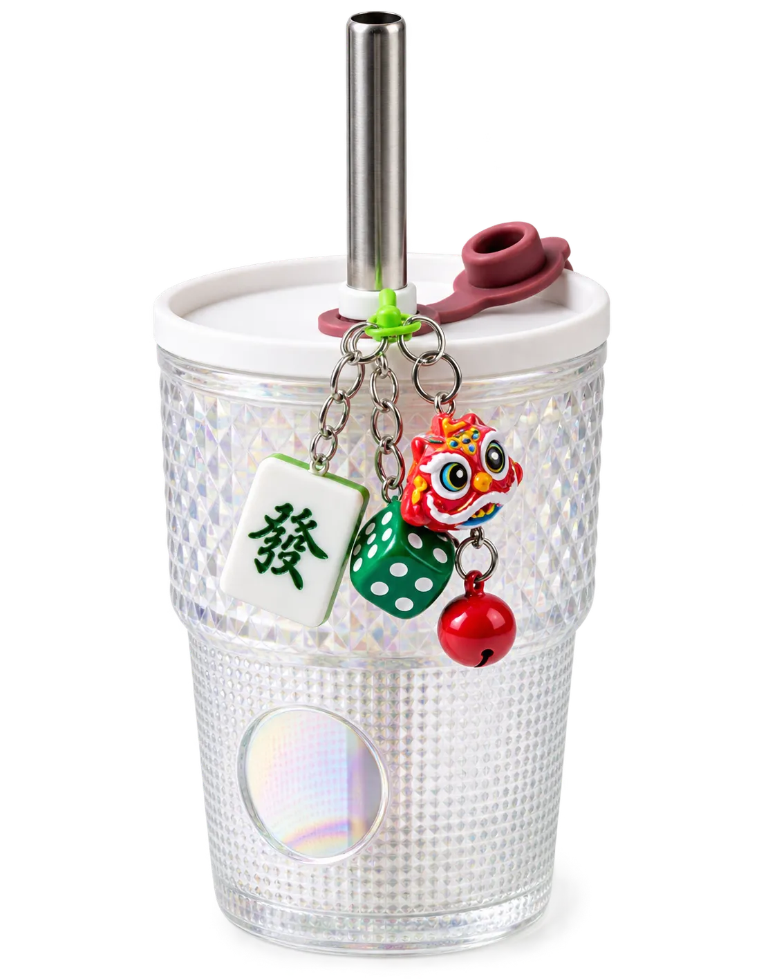 A textured tumbler with a metal straw and a keychain with a Mahjong tile, die, and lion head charms.