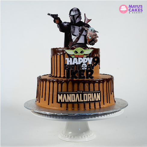 Two-tiered cake with 'The Mandalorian' theme and character toppers.