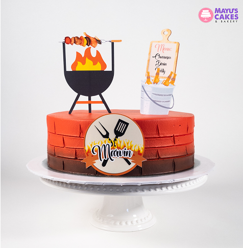 Orange cake with barbecue grill and menu decorations on top.
