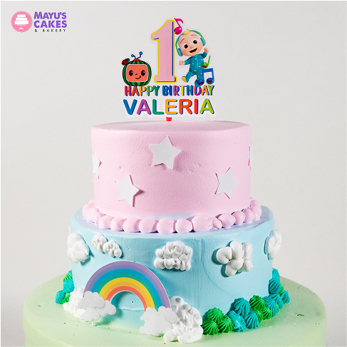 Two-tiered birthday cake with rainbow, clouds, and star decorations.