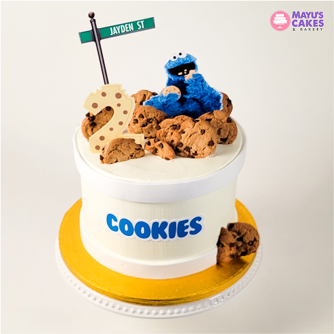 Cake with cookies, number two, and blue character on top.