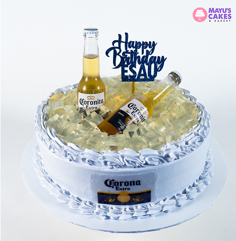 White cake with two Corona bottles and 'Happy Birthday Esau' topper.