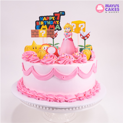 Pink birthday cake with Mario-themed decorations and 'Happy 7th Birthday Emma' topper.