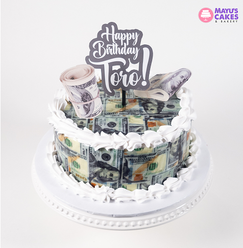 Birthday cake decorated with dollar bills and a 'Happy Birthday Toro!' topper.