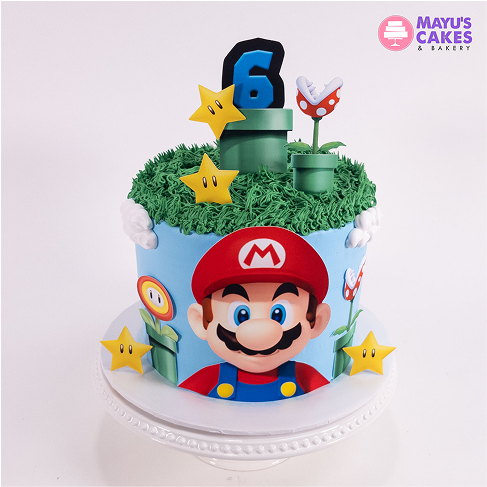 Super Mario-themed cake with stars, a pipe, and a number six topper.