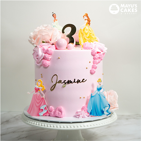 Pink birthday cake with princess figures and the name 'Jasmine' on it.