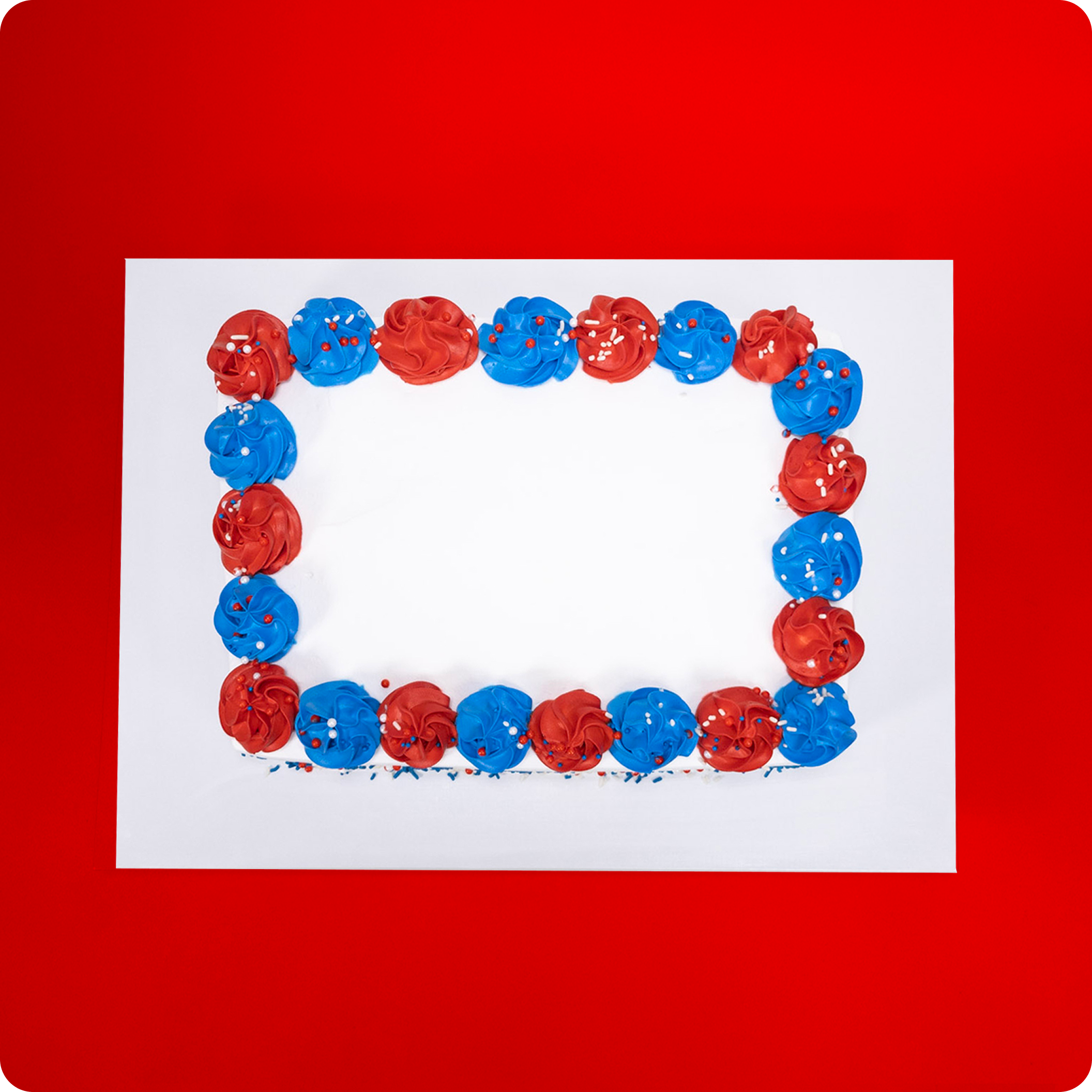 Rectangular cake with red and blue frosting on a red background.
