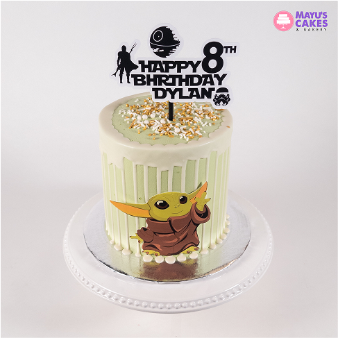 Green birthday cake with Baby Yoda decoration and 'Happy 8th Birthday Dylan' topper.