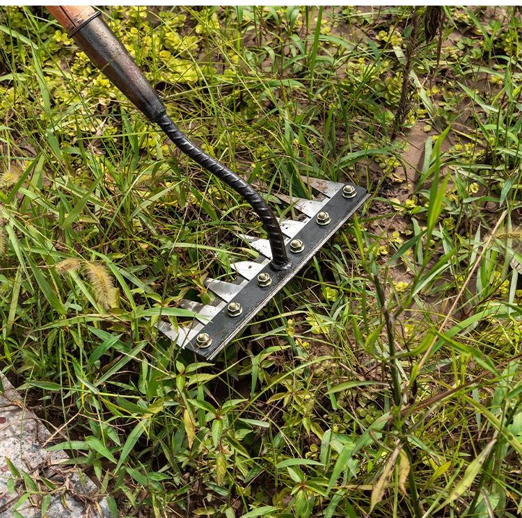 Metallic tool with sharp, angled blades and a flexible, coiled handle on a patterned surface.