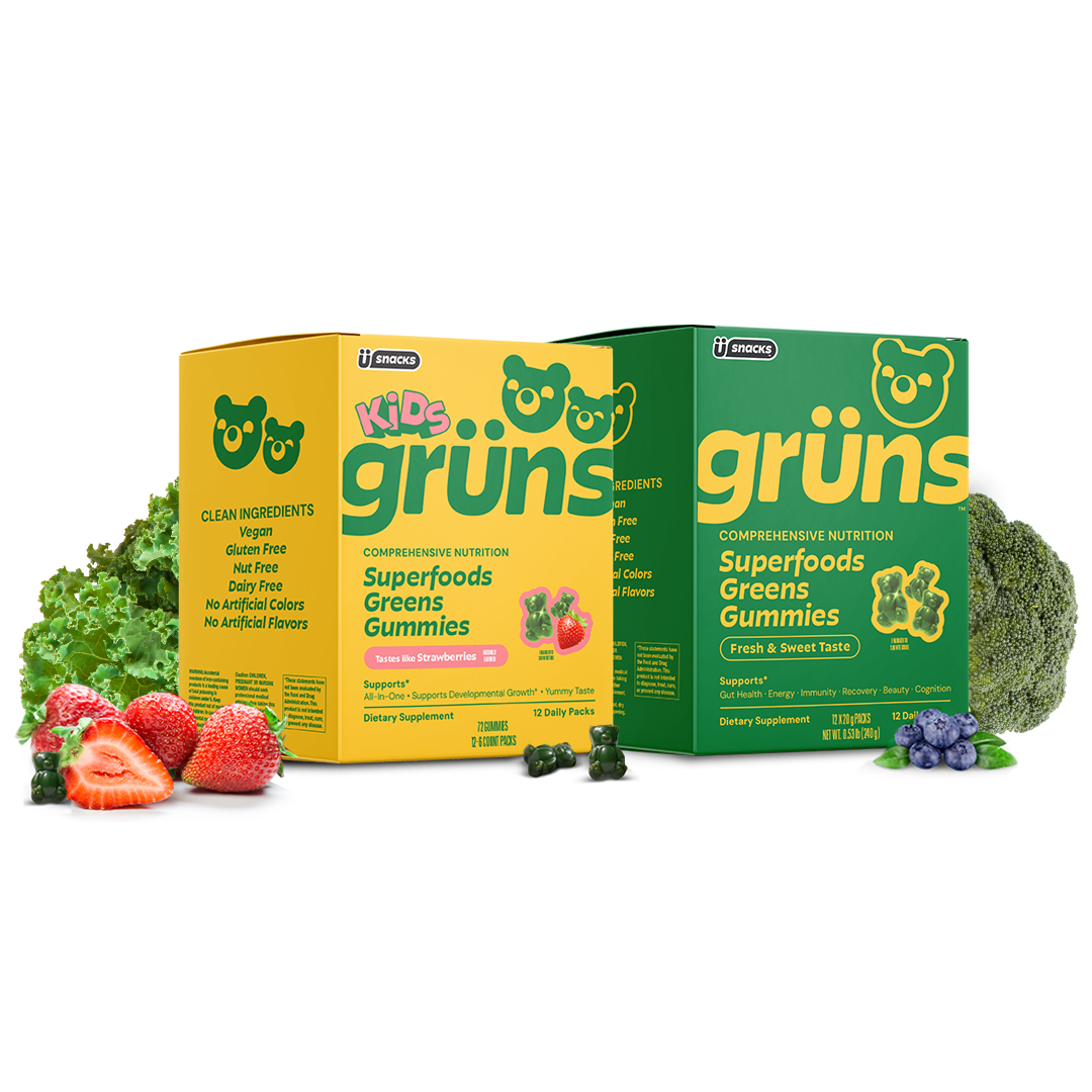 Two boxes of superfoods gummies with strawberries, kale, and broccoli around.