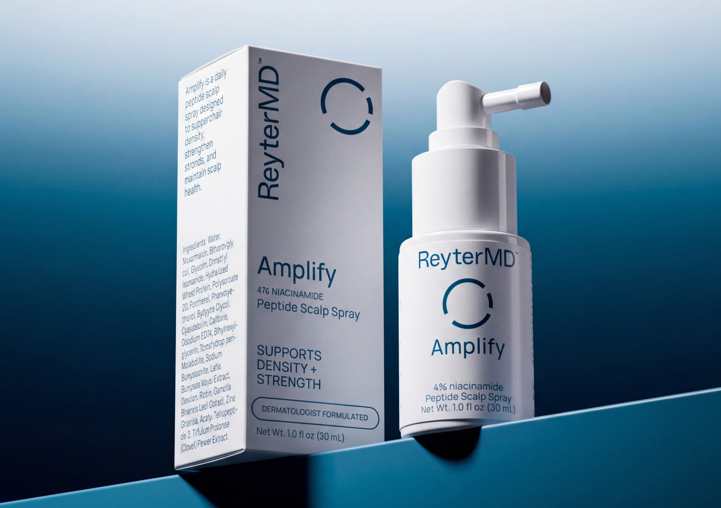A white bottle of ReyterMD Amplify Peptide Scalp Spray next to its packaging box on a blue surface.