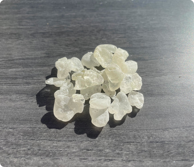 Small translucent stones on a dark surface.