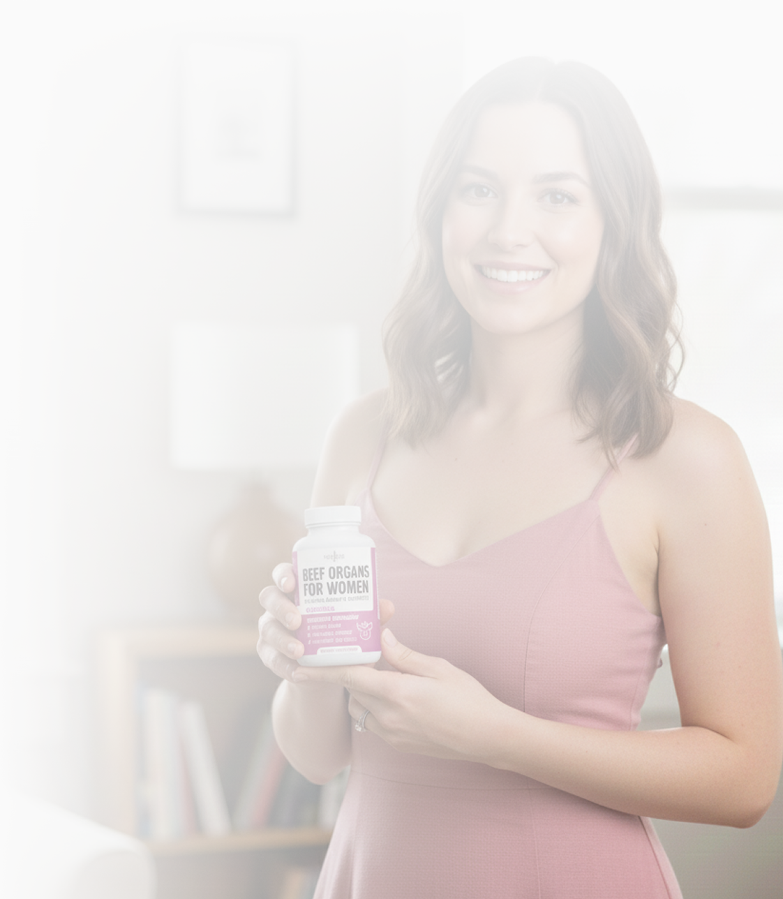 Woman holding a supplement bottle labeled 'Beef Organs for Women' in a softly lit room.