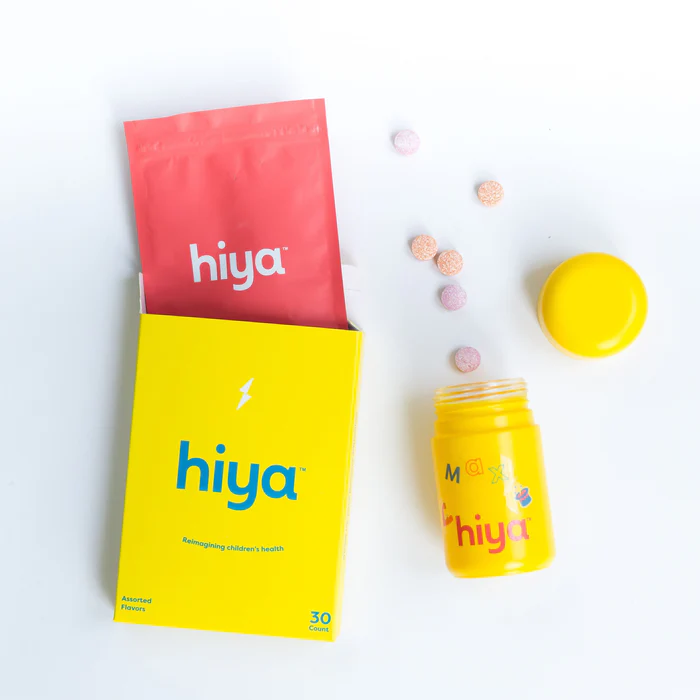 Yellow box and container with pills, labeled 'hiya'.