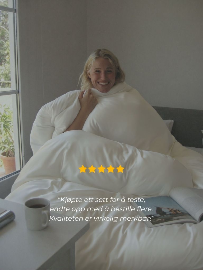 A smiling woman sits up in bed, wrapped in a large white comforter, with a testimonial overlay.