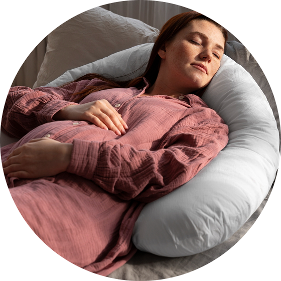 Person in pink shirt sleeping on a white pillow.