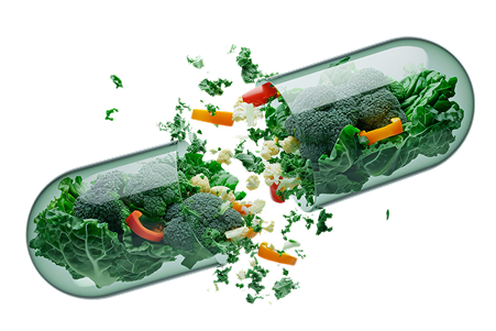 A capsule filled with broccoli, lettuce, and bell peppers, with vegetables spilling out.