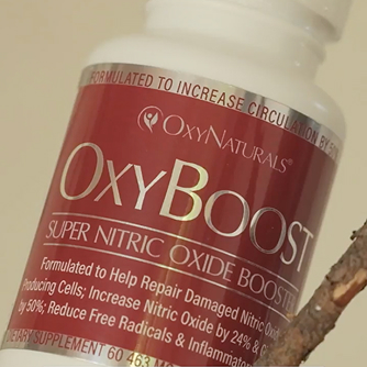 Bottle of OxyBoost supplement with red label and text.