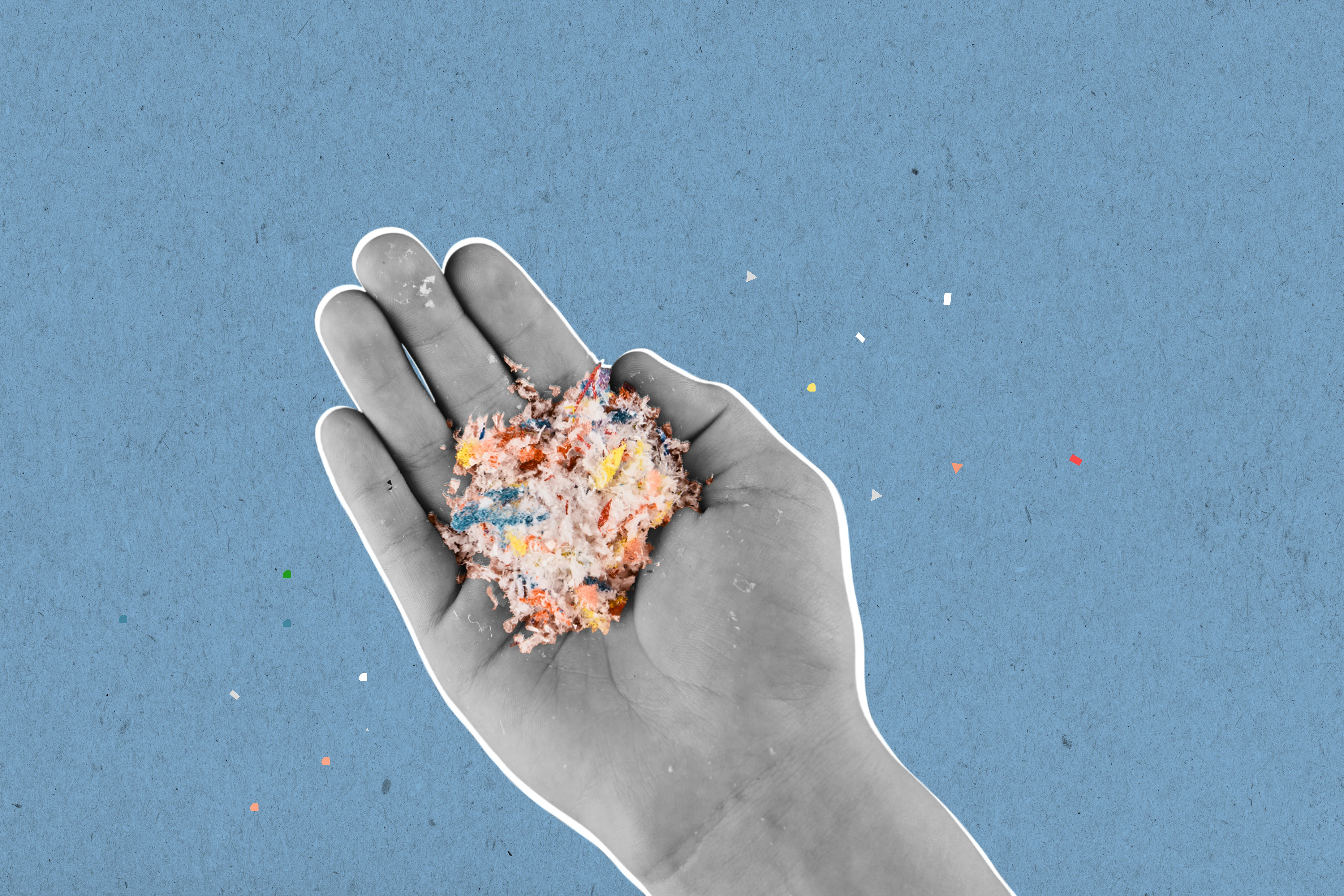 A black-and-white hand with a white outline holds a handful of colorful shredded material against a blue background.