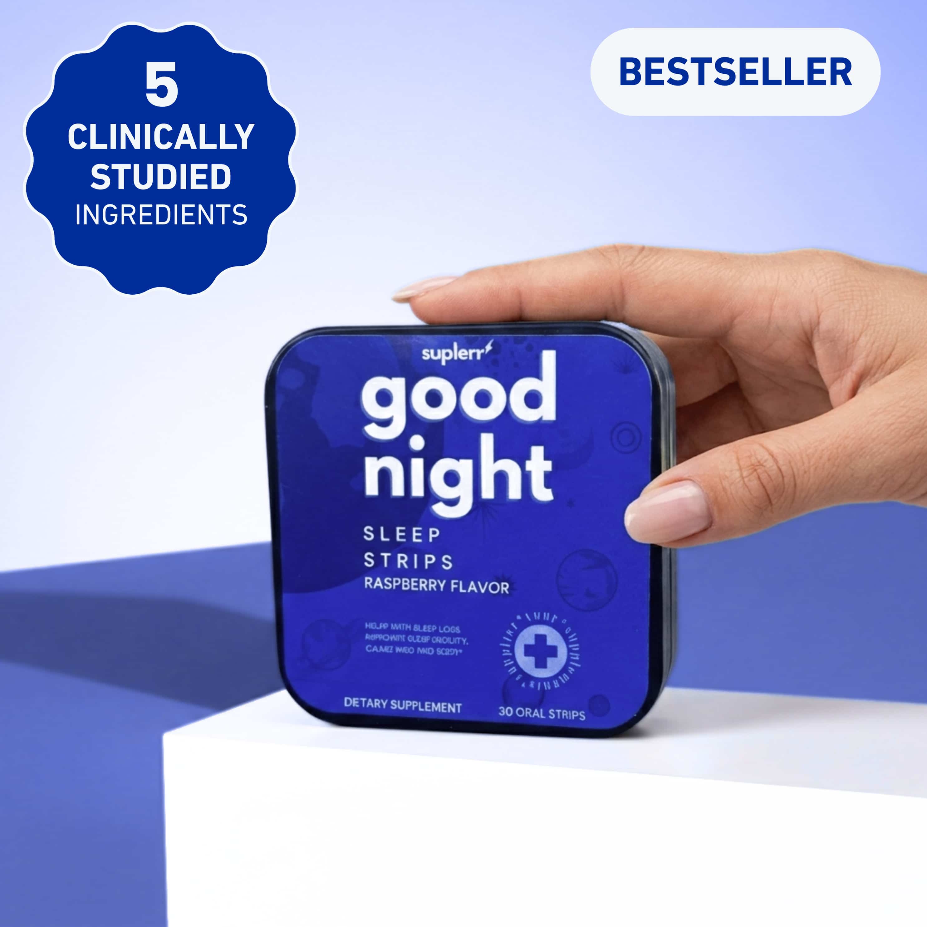 A person's hand holds a small blue tin of Suplerr Good Night Sleep Strips against a blue background.