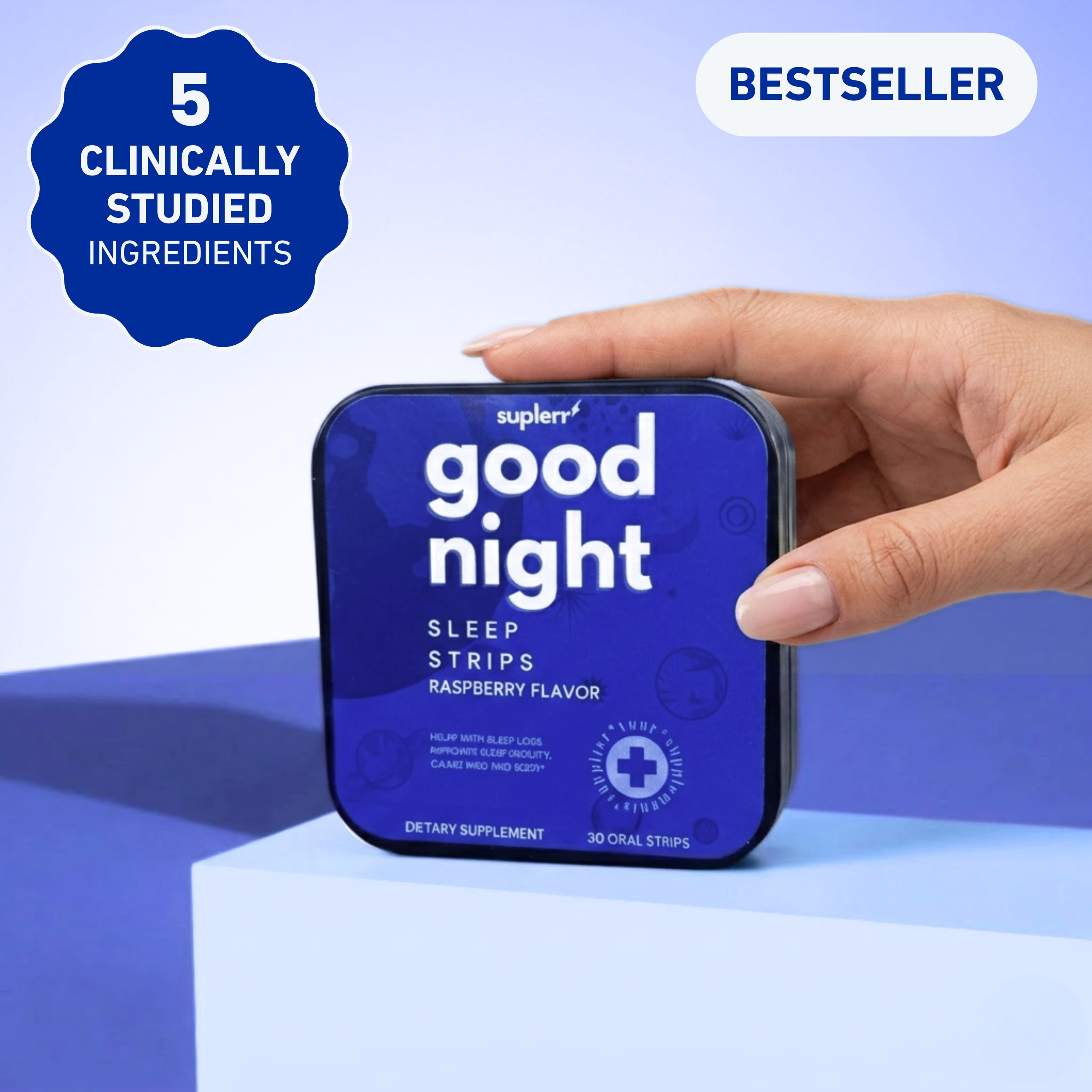 A hand holds a blue tin of Suplerr Good Night Sleep Strips, a raspberry-flavored dietary supplement.