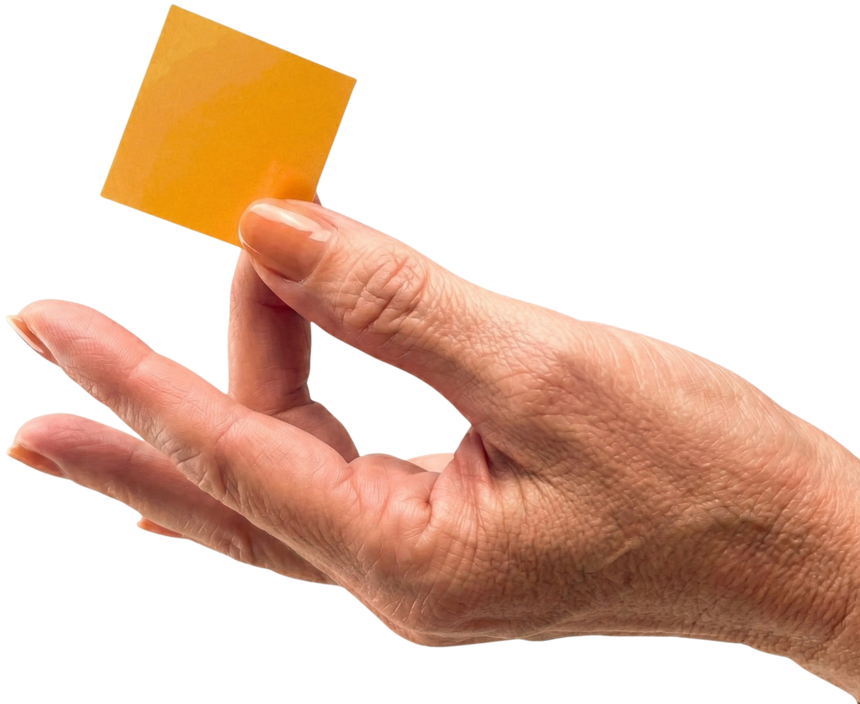 A hand holding a small, orange square piece of paper against a white background.