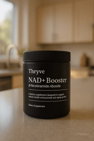 Black jar labeled 'Thryve NAD+ Booster' on a kitchen counter.