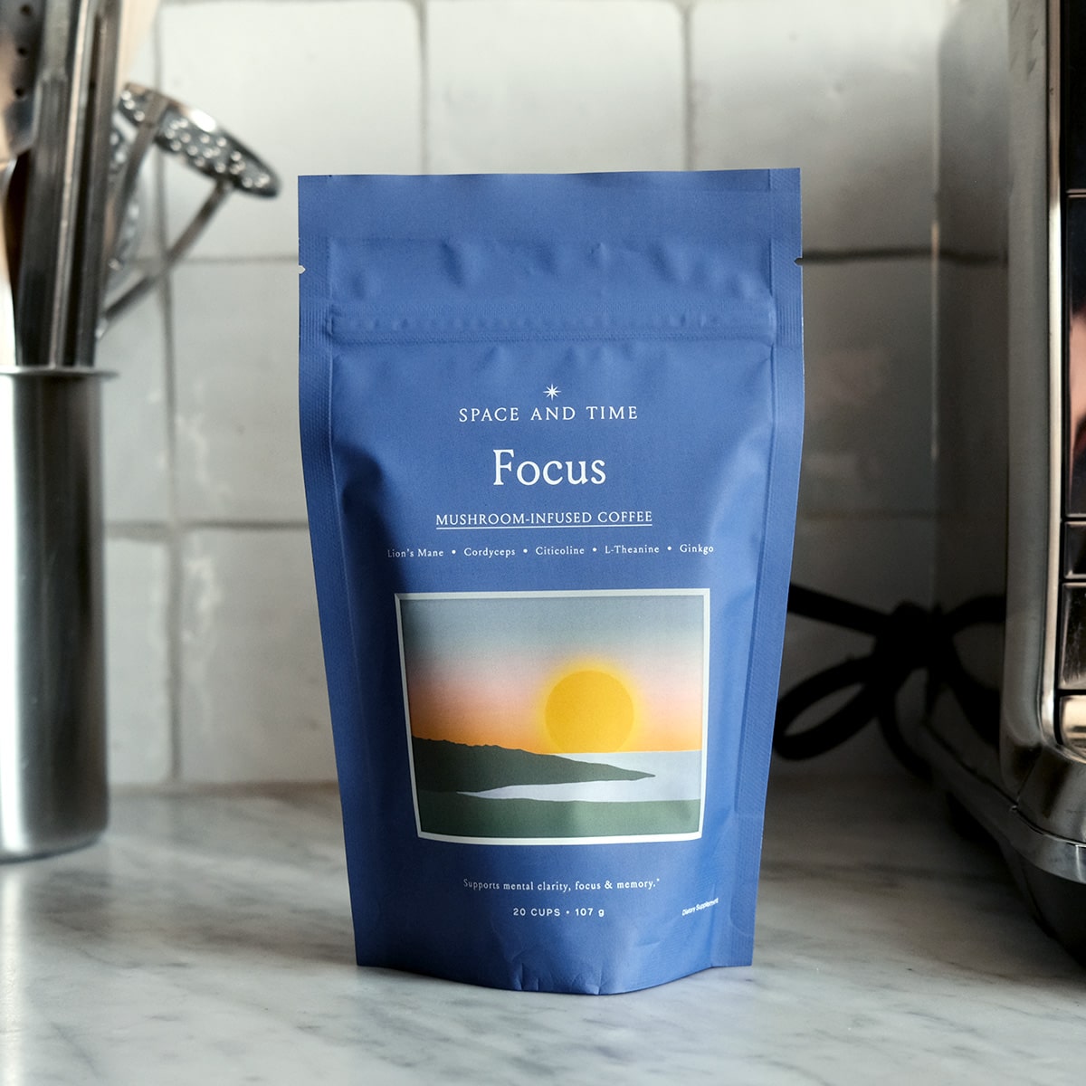 Blue coffee package with sunrise illustration and text about mushroom-infused coffee.