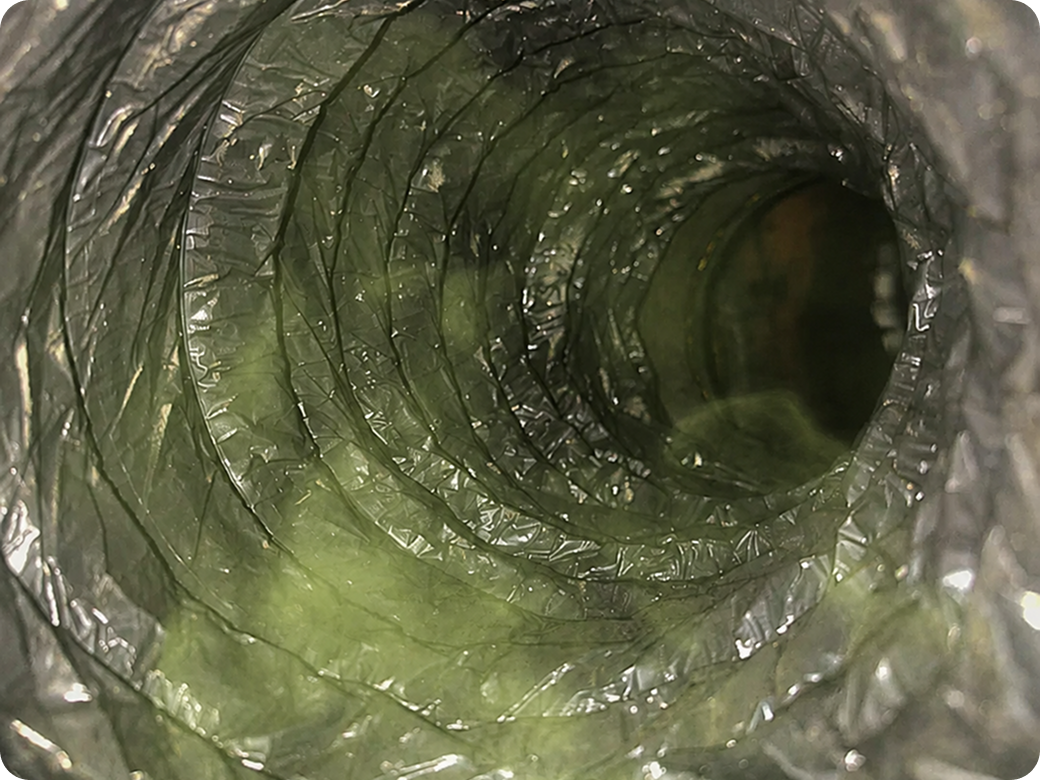A blurry, high-angle view of a trash can filled with various plastic bottles and containers.