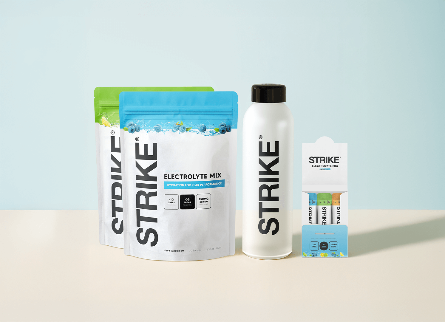 Product shot of STRIKE Electrolyte Mix pouches, a water bottle, and single-serving stick packs against a two-toned background.
