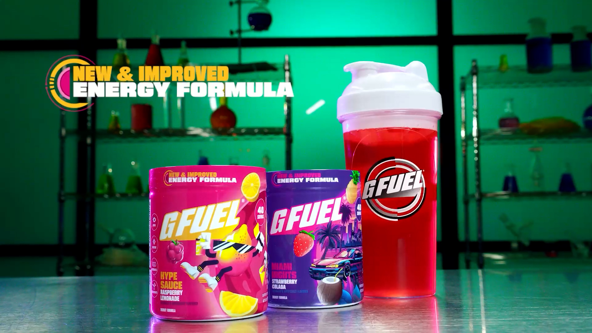 G Fuel energy formula containers and shaker in lab setting with colorful background.