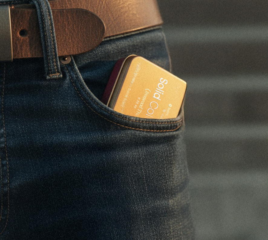 Small tin labeled 'Solid Cologne' in a denim pocket.