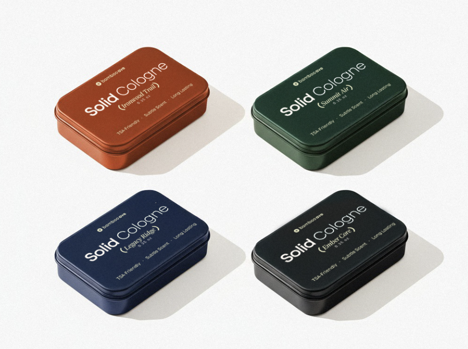 Four rectangular tins of solid cologne in different colors.