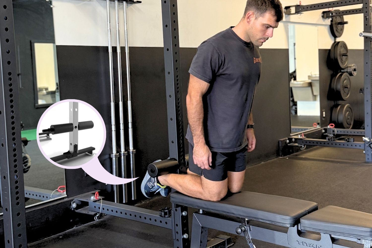 Man kneeling on gym equipment with a focus on a leg support attachment.
