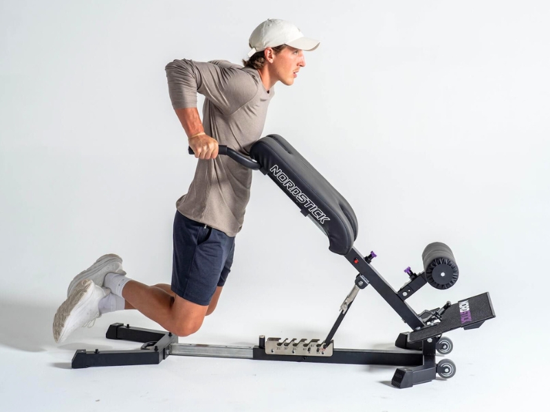 Person using a Nordic exercise machine on a white background.