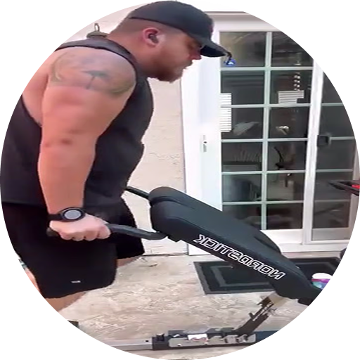 A man in a black tank top and baseball cap performs a tricep dip on a NordicTrack workout bench.