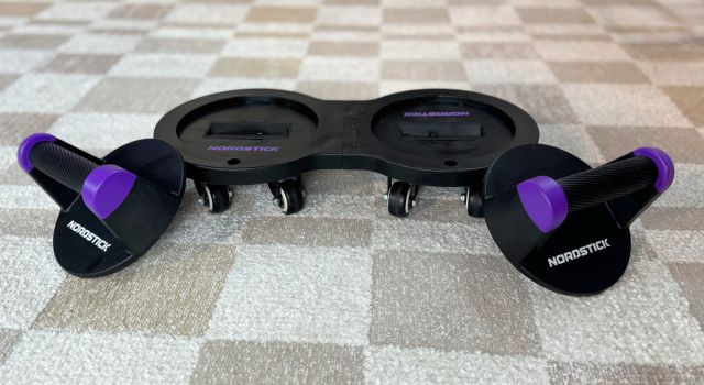 Nordstick exercise equipment on a checkered carpet.