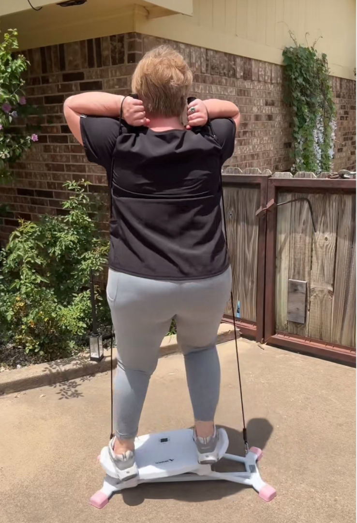 Person exercising on a balance board outdoors.
