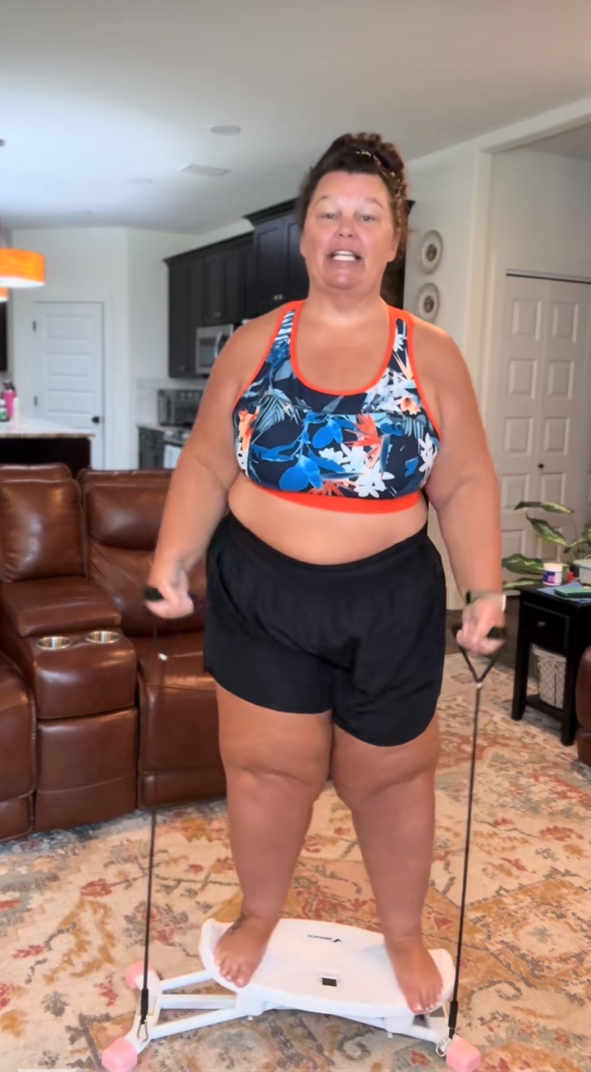 Person exercising on a balance board in a living room.