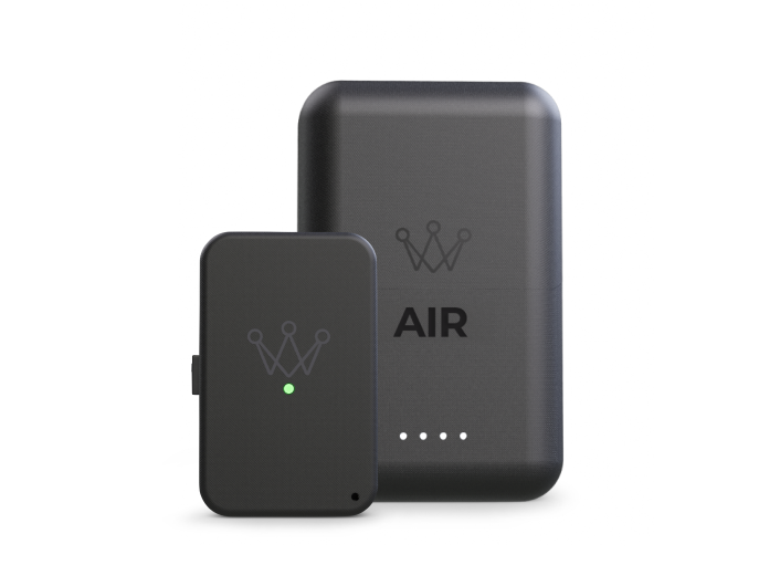 A small black device with a green light standing in front of a larger one labeled AIR.
