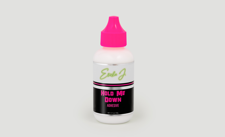 A white bottle of Ericka J. Hold Me Down Adhesive with a bright pink cap against a grey background.