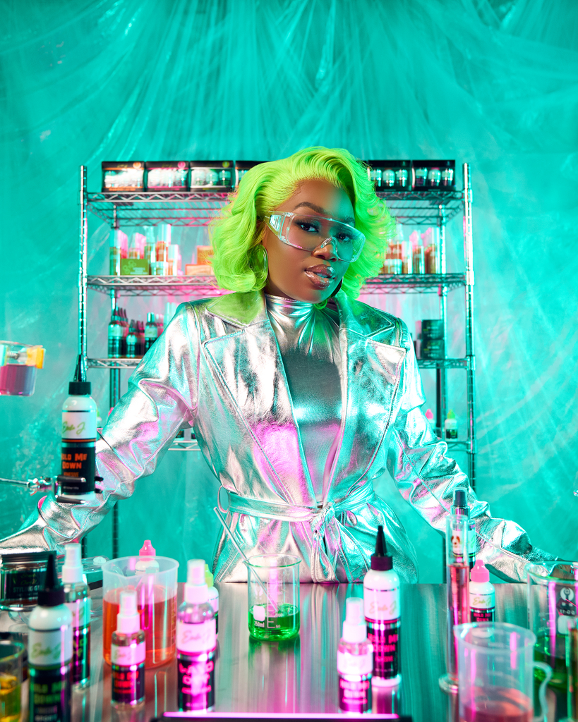 Ericka J founder posing with lace care products in studio