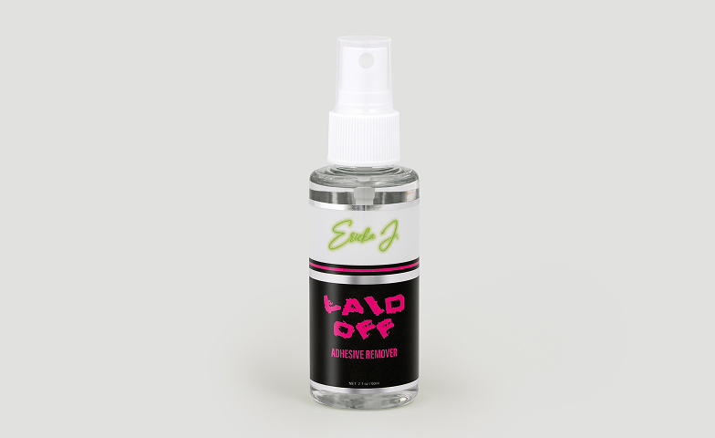 A clear spray bottle of Ericka J's Laid Off Adhesive Remover against a plain grey background.