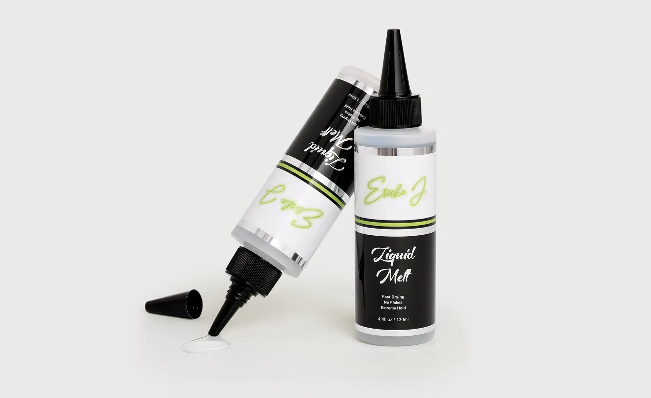 Two bottles of Ericka J Liquid Melt, with one dispensing a small amount of the white product.
