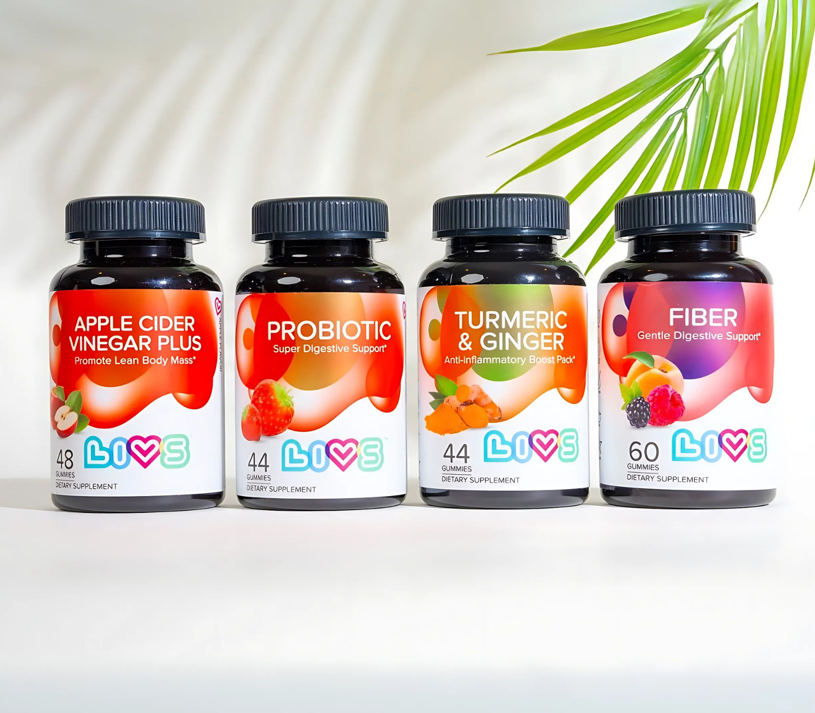 Four supplement bottles labeled Apple Cider Vinegar, Probiotic, Turmeric & Ginger, and Fiber.