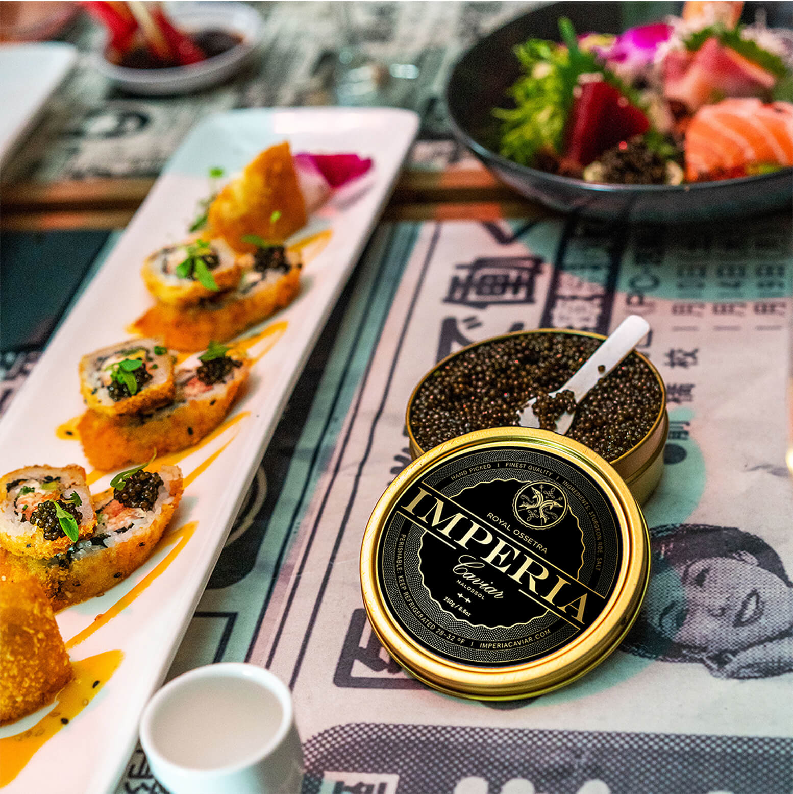 Plate of sushi and open tin of caviar on a decorative table setting.